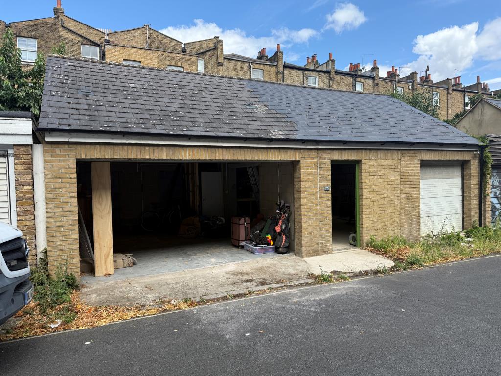 Lot: 21 - FREEHOLD GARAGE/WORKSHOP OF APPROXIMATELY 700 SQ.FT - View of front elevation with open roller door